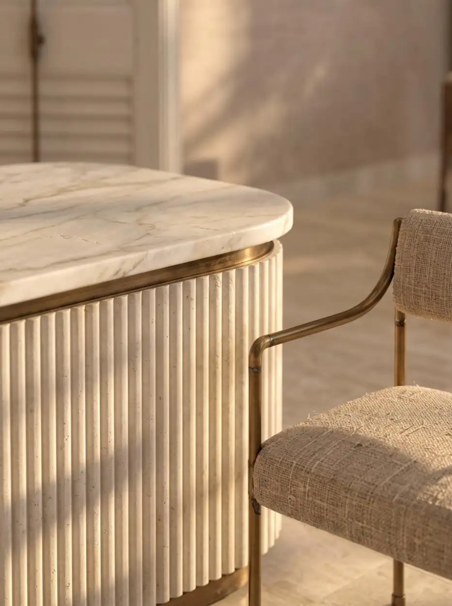 Fluted counter with a marble top beside a linen chair