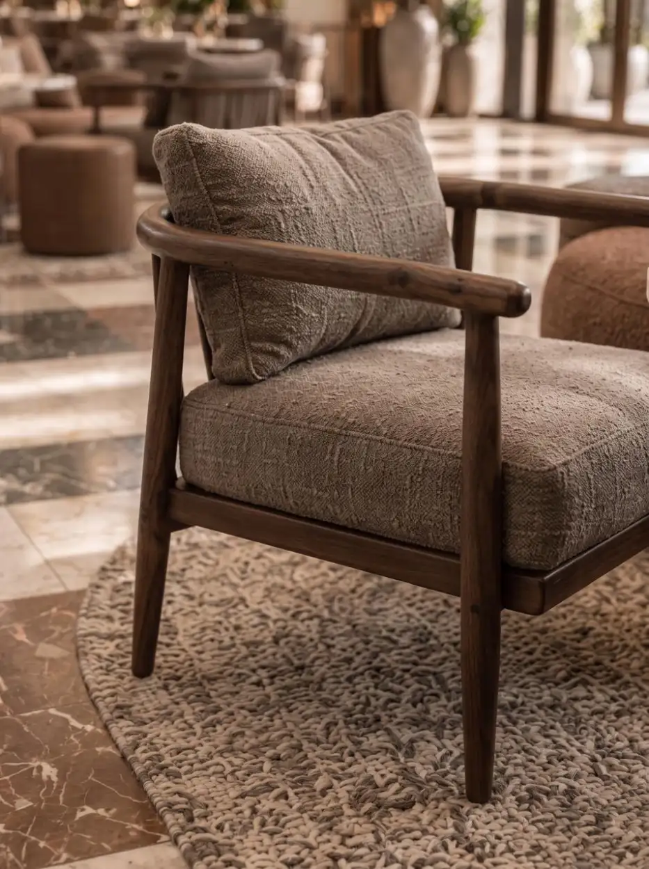 Timber armchair with a grey cushion on a patterned rug